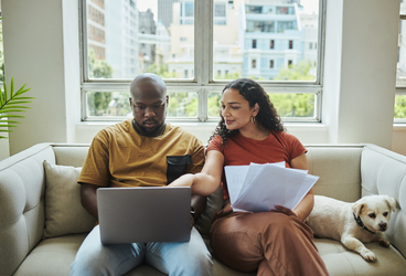 Couple on laptop working on their financial plan.
